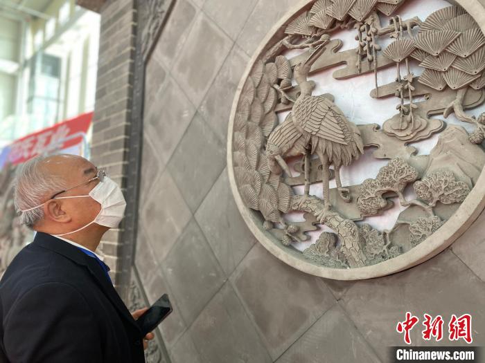 圖為2021邯鄲永年秋季房地產(chǎn)、家裝建材暨汽車博覽會(huì)上，一客戶在駐足觀看展出的磚雕產(chǎn)品。(資料圖) 趙明 攝