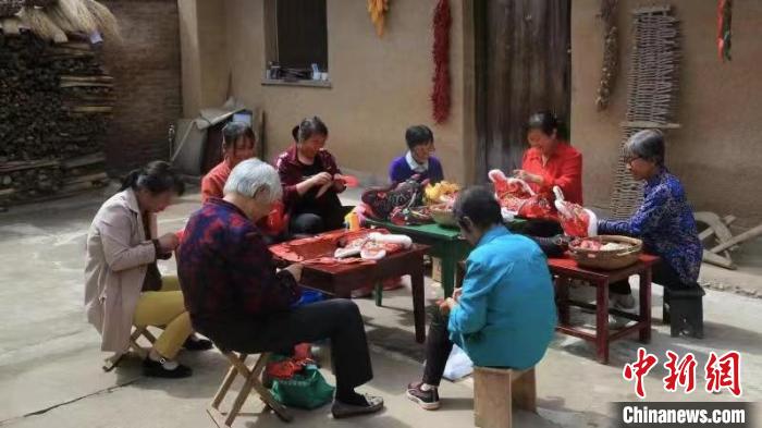 圖為李惠蓮和鄰里婦女們一起制作刺繡工藝品。　受訪者供圖