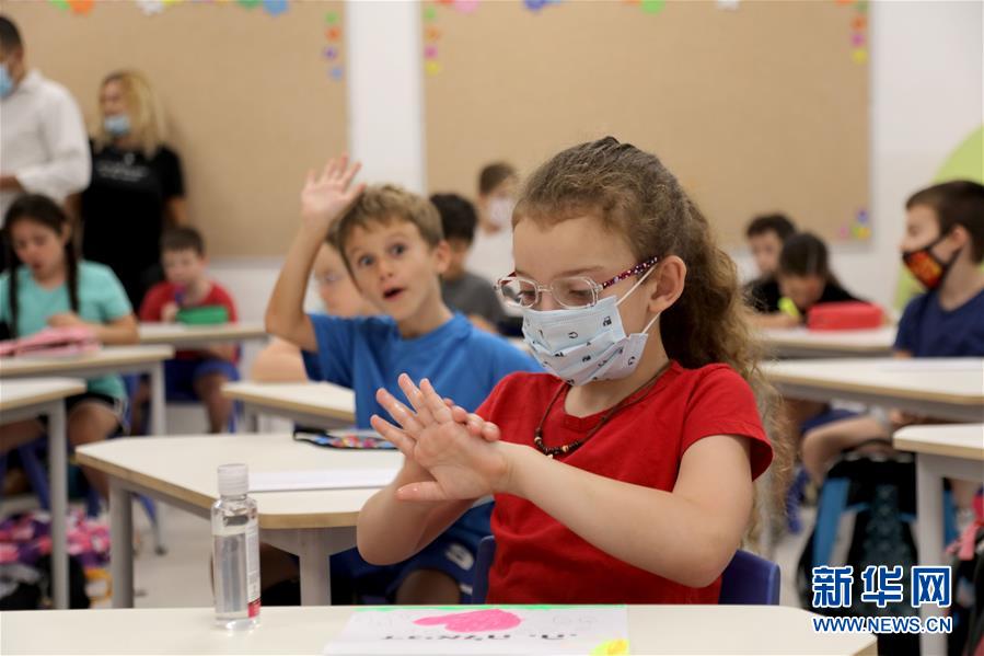 這是9月1日在以色列中部城市特拉維夫一所小學(xué)的教室內(nèi)拍攝的佩戴口罩的學(xué)生。 以色列中小學(xué)的新學(xué)年于9月1日開始，低年級（1至4年級）進(jìn)行小班教學(xué)，中高年級（5至12年級）則主要是遠(yuǎn)程在線學(xué)習(xí)。 新華社/基尼圖片社